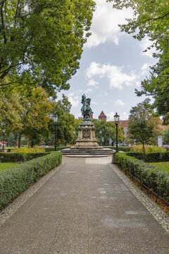 View of the King John III Sobieski monument standing in a park with manicured hedges and trees in Gdansk, Pomeranian Voivodeshi, Poland.