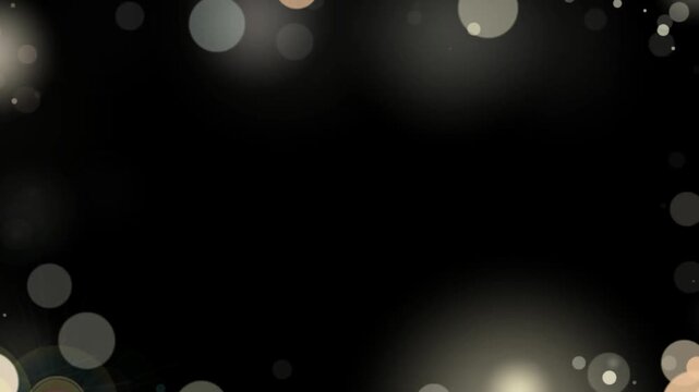Bokeh lighting effect featuring soft white and gold glowing orbs forming a decorative frame on black backdrop.