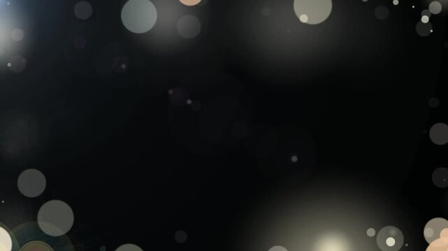 Soft white bokeh circles glow on a dark background creating a subtle luminous border with an empty center for adding text.