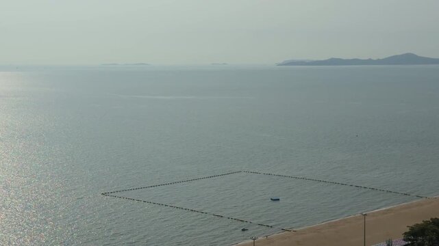 An overhead view of the endless expanse of the sea with islands on the horizon.
