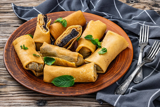 Rolled pancakes with poppy seed filling on plate