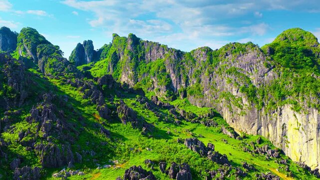 Dramatic karst mountain ridges covered with lush vegetation stretch under a clear blue sky in Liupanshui, Guizhou.