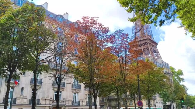 Eiffel Tower peeking through colorful autumn trees in Paris