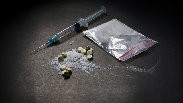 Some drugs, syringe and medical plastic clip. Illegal and misused drugs concept. 