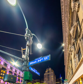 West 34th Street and Sixth Avenue signs surrounded by Manhattan skyscrapers