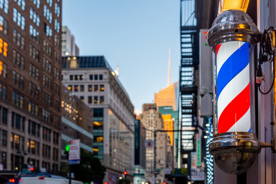 Vintage blue white and red barber pole with Manhattan at sunset