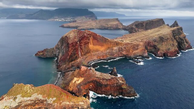 Rugged Ponta de Sao Lourenco peninsula and volcanic cliffs form distinctive eastern coast of Madeira, Portugal. Aerial view over Atlantic Ocean