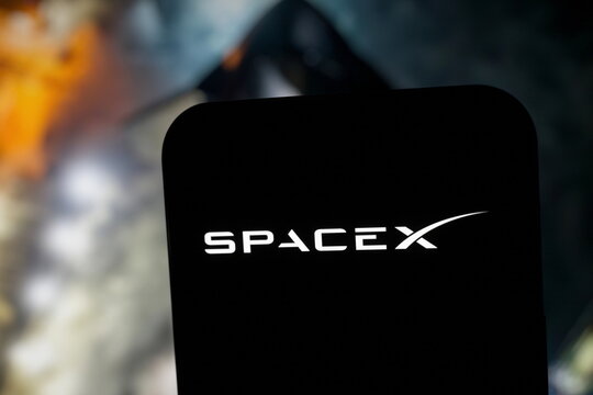 Close-up: the SpaceX logo displayed on a smartphone screen. SpaceX Starship Completes First Orbital Test Flight Before Splashdown. September 30, 2026, Lisbon, Portugal.