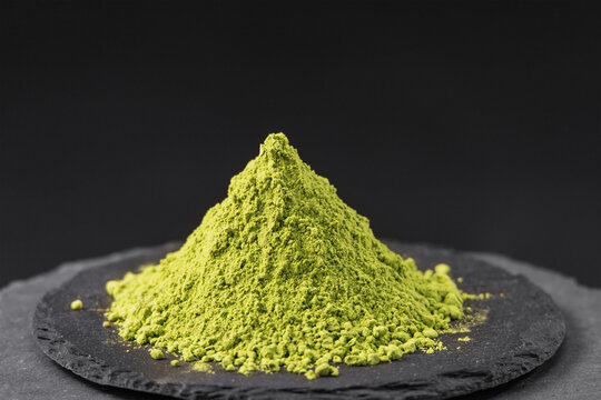 dried barley grass powder on a black slate stone tray
