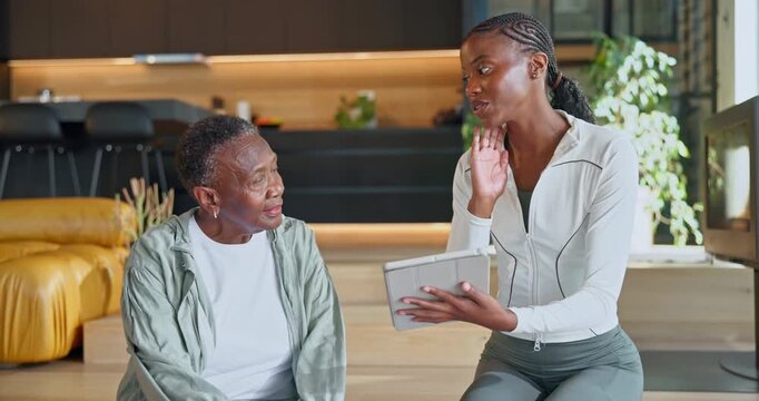 Personal trainer, senior woman and tablet in home for exercise regimen, schedule or explain for wellness. Advice, online guide or fitness tips with black person and instructor for training and health