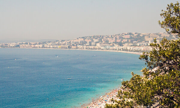 Baie des Anges, crowded beach and Nice cityscape, France