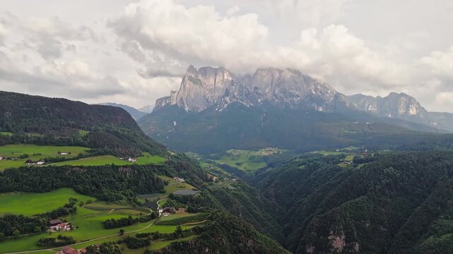 Dolomites landscape with rocky mountains and alpine valley in South Tyrol, Italy, aerial view of natural terrain and forested hills