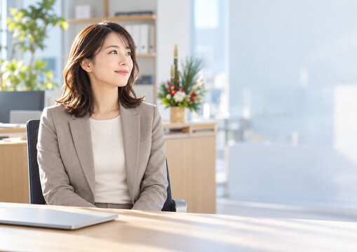 Businesswoman pausing before work in bright office with New Year decor