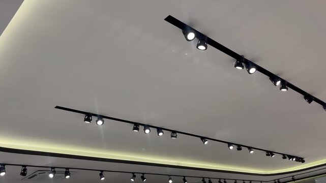 Modern Interior Ceiling Design with Black Track Spotlights and Hidden Cove Lighting