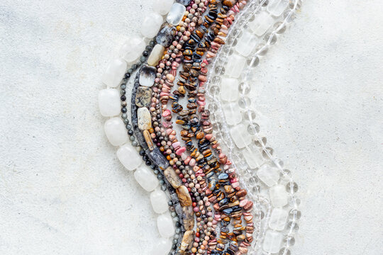 Jewelry and precious concept. Gemstones and beads for necklace, top view, flat lay