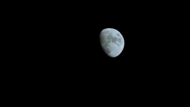 large blue moon passing through the night sky