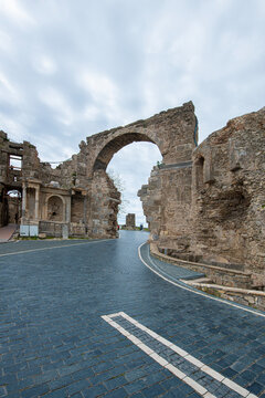 Side Ancient City. It shows the remains of an ancient structure and a stone-paved road passing through them. As indicated in the file name, these remains belong to the Vespasian Fountain and the Monum