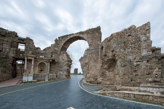 Side Ancient City. It shows the remains of an ancient structure and a stone-paved road passing through them. As indicated in the file name, these remains belong to the Vespasian Fountain and the Monum