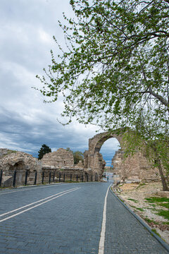Side Ancient City. It shows the remains of an ancient structure and a stone-paved road passing through them. As indicated in the file name, these remains belong to the Vespasian Fountain and the Monum
