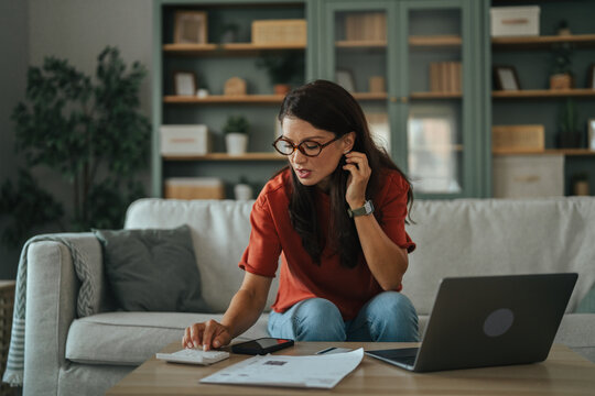 Woman calculating home finances struggling with bills