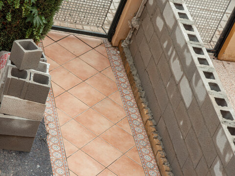 High angle view of outdoor construction site with concrete blocks and tiled flooring in progress