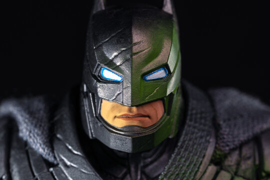 Detailed close up face front view of DC Comics Batman Bruce Wayne action figure cowl mask with glowing blue eyes on black background