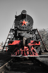 Steam locomotives with red star stands on the railroad tracks in the museum exposition. Museum complex of the locomotive depot Podmoskovnaya.  © VLAD ANTONOV