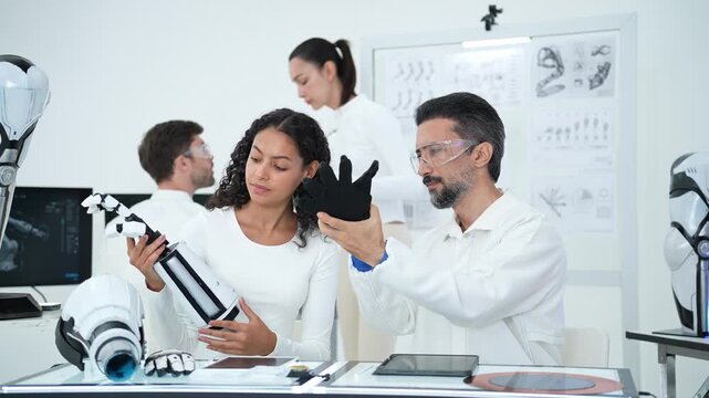 A research team collaborates in a modern laboratory to assemble and test advanced robotic prosthetics, driving innovation in biomedical engineering and rehabilitation technology.