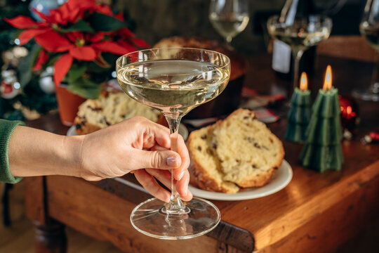 Festive Holiday Table With White Wine Glasses, Cheese Board, Olives and Christmas Tree Decorations