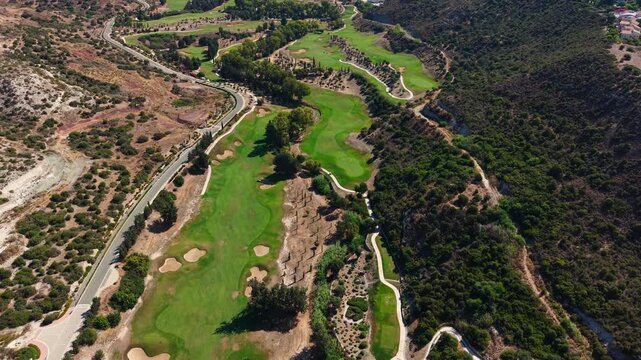 Drone View of Secret Valley Golf Course Under Aphrodite Hills in Landscape of Cyprus on Sunny Summer Day
