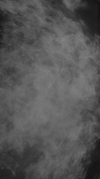 Luminous white mist and vapor swirls vertically against a dark backdrop in a seamless loop 3D motion background