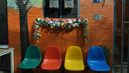 Colorful Chairs Against Decorated Brick Wall in Taichung, Taiwan © ThaiKhanh