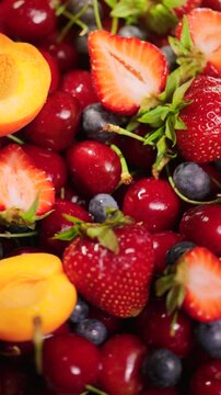 Background of fresh fruits and berries rotating. Vegan sweet food, flat lay.