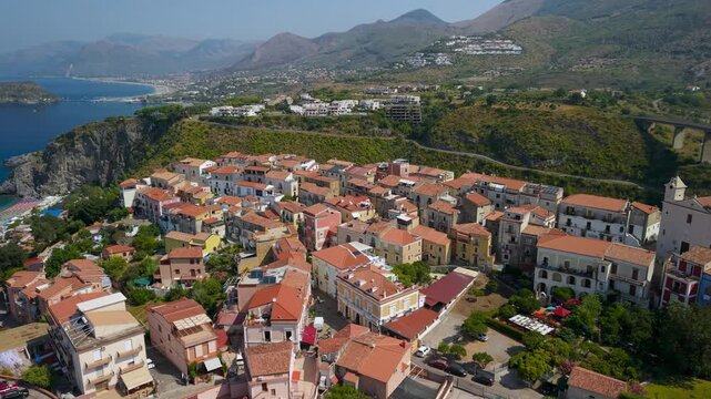 San Nicola Arcella Calabria Italy 4k drone view of historic town arcade bridge. Sideways flyby to beach and coastal cliffs with Isola di Dino island in distance b-roll establishing video footage
