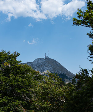 Rocky mountain peak of Kuk in Lovcen National Park with a communication tower on its summit, Montenegro