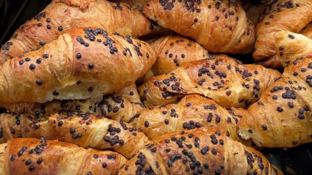 selective focus chocolate croissants displayed in bakery showcase close up