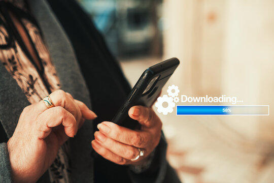 Downloading app and documents on smartphone with progress bar hologram. App updates, software installation, digital literacy for seniors, mobile technology, and data transfer.