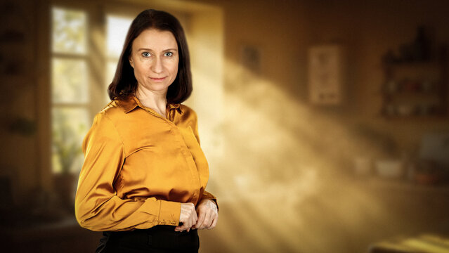 Woman in cozy  home interior, surrounded by warm furnishings and welcoming domestic atmosphere. Soft natural light and softly blurred background.