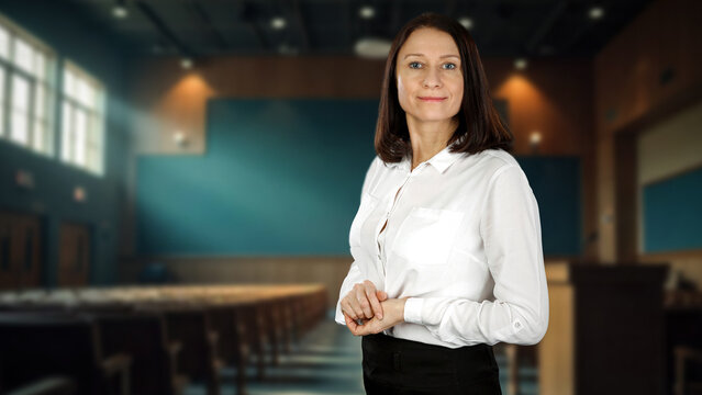 Female teacher or lecturer in classroom &ndash; education and academic learning concept.