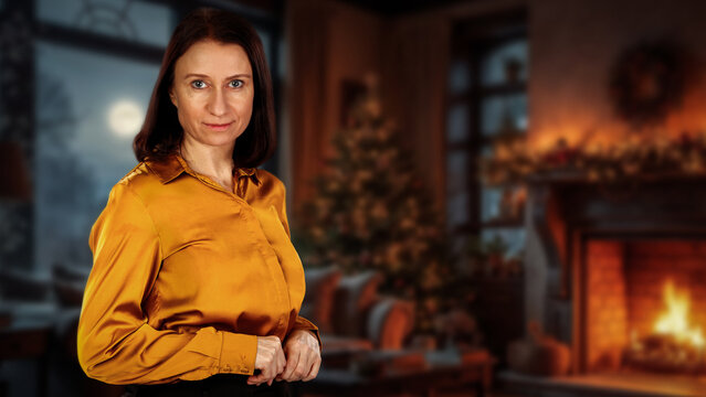 Woman with fireplace and beautifully decorated Christmas interior in the background. Warm lighting, seasonal decorations, and a cozy home setting.