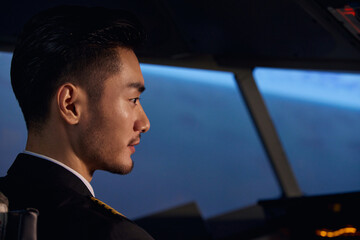 Young male pilot in cockpit side profile © LeNgoc