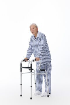 Senior Man in Pajamas Using a Walker for Mobility Support
