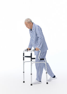 Elderly Man in Pajamas Using a Walker for Mobility Support