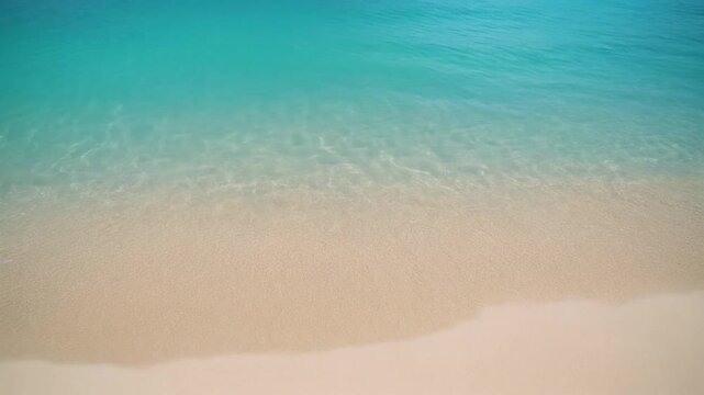 Crystal clear turquoise water gently washing ashore on a pristine white sandy tropical beach vacation background