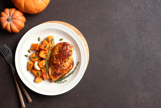 Autumn meal: roasted chicken breast and pumpkin with herbs