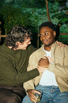 Two best friends expressing feelings with each other while spending leisure time in courtyard
