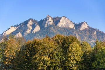 Trzy Korony limestone peaks above autumn trees in the Pieniny Mountains © mkos83