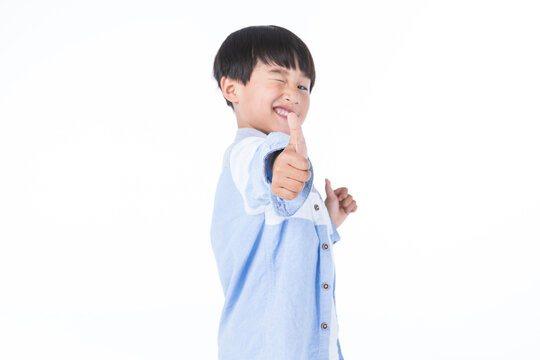 Happy Young Boy Winking and Giving Thumbs Up