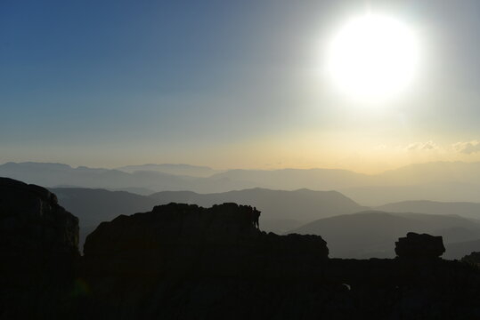 Rocky Highland Summit with Tiny Adventurers and a Radiant Open Sky