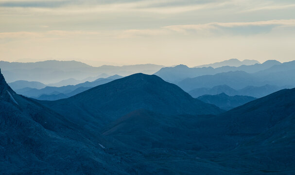 Minimalist Mountain Panorama with Receding Ridges and Muted Sunset Colors